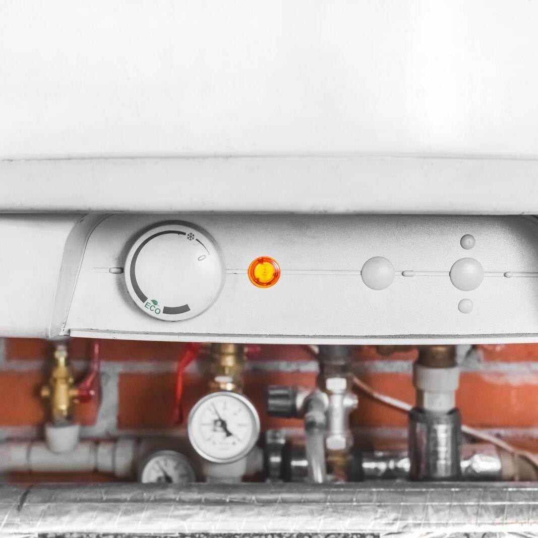 A boiler and a pipe system with water heating equipment and a gauge at an industrial plant in the workshop A boiler and a pipe system with water heating equipment and a gauge at an industrial plant in the workshop.